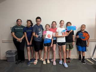 Children standing in a group after playing the Pippa Park Escape Room