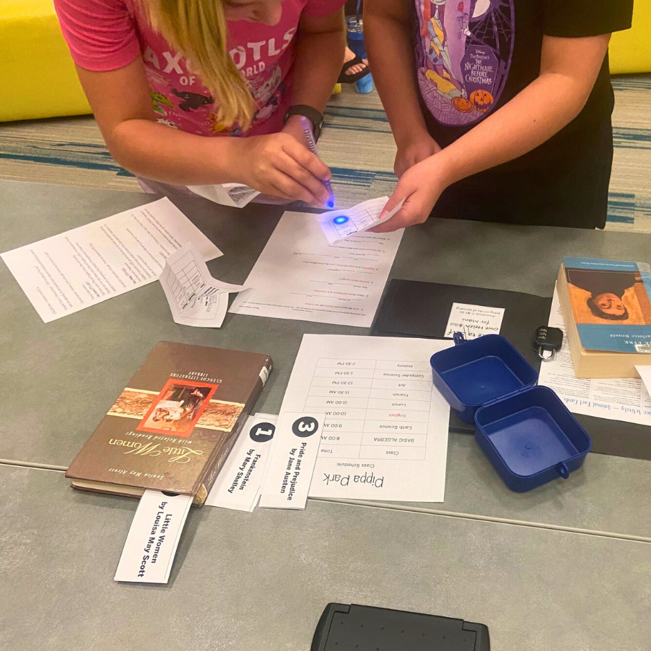 Kids participating in the Pippa Park Escape Room Activity at the Bonham Public Library