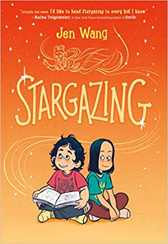 A girl is sitting down cross legged with an open book in her hand and looking towards the title while the girl beside her, also cross legged, is looking at her friend. From the book are light orange swirls that create a dragon which decorates the book title. 